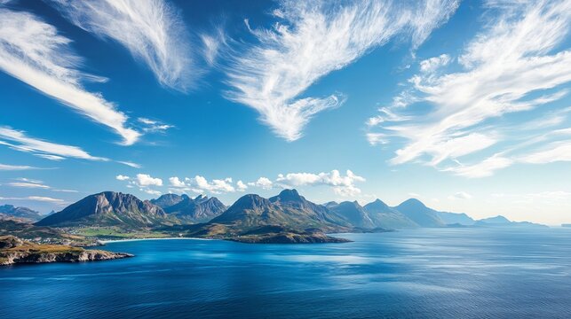 A high-angle view of the sea and mountains against a blue sky.