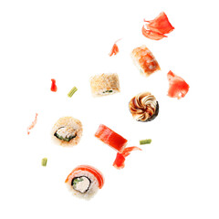 Tasty flying sushi rolls and ginger on white background
