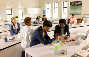 In high school, teenagers conducting science experiments in classroom laboratory setting