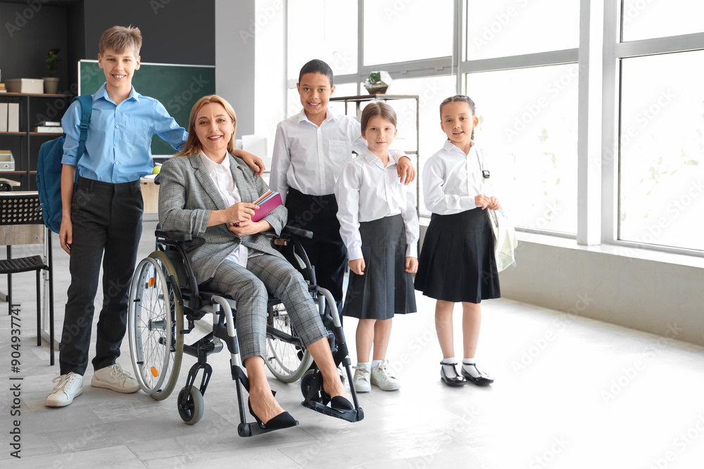 Canvas Prints Mature teacher in wheelchair with little pupils at school