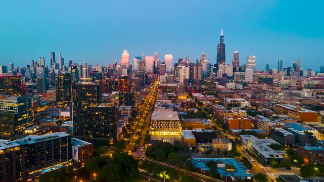 Aerial hyper lapse drone view of a vibrant cityscape of Chicago at night, illuminated by the dazzling bursts of fireworks along a bustling main street. people celebrate their independence and freedom