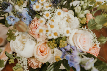 Close-up of a mixed wildflower flower bouquet with roses and greenery