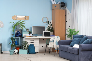 Interior of teenager's room with workplace and sofa