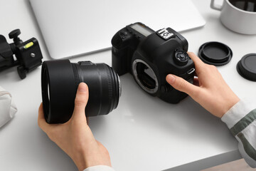 Female photographer with professional equipment at light table, closeup