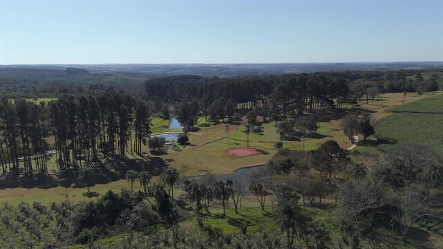Middle altitude and approaching aerial movement about the local golf club and green tea fields, Argentina.