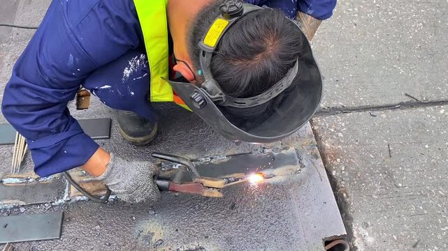 a construction worker welding metal beams