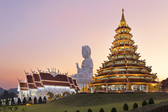Nine-storey Chinese pagoda and chapel in front of huge Guan Yin statue at sunset, Wat Huay Pla Kang temple, Kuan Yin, Chiang Rai, Northern Thailand, Thailand, Asia