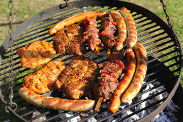 various meat and sausages on the charcoal grill