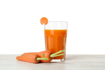 Fresh carrot juice in glass and vegetables on wooden table against white background