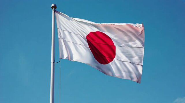 Japan flag waving in the wind against blue sky background. Patriotism and national pride concept. Government and politics. Cultural heritage
