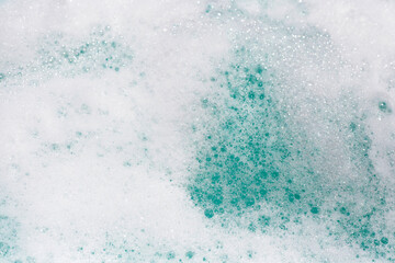 Detergent foam bubble on water. Blue background, Soap sud