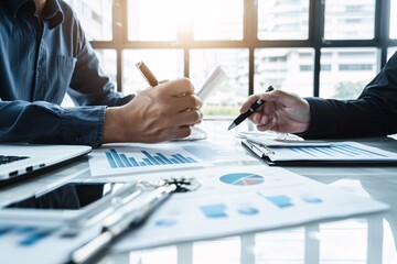 An investment planner discussing asset allocation strategies with a client, emphasizing the importance of diversification to minimize risk, in a modern office setting