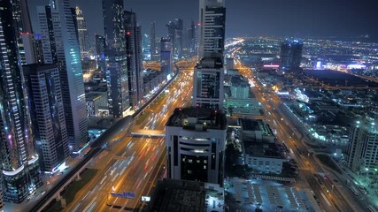 Night cityscape with skyscrapers, illuminated highway, dynamic urban area, bustling city life