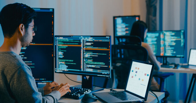 Group Adult Asia male, female freelance typing write prompt AI bot IT app smart program nomad, video game, terminal with coding language, designer, big data center on desktop computer in night office.