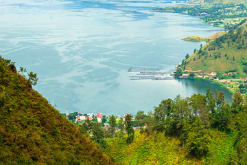 Picturesque view of Toba Lake with green hills scenery in Karo, Sumatra Utara, Indonesia.