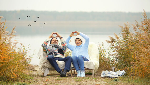 smiling happy elderly couple in love - spend their time outside in winter