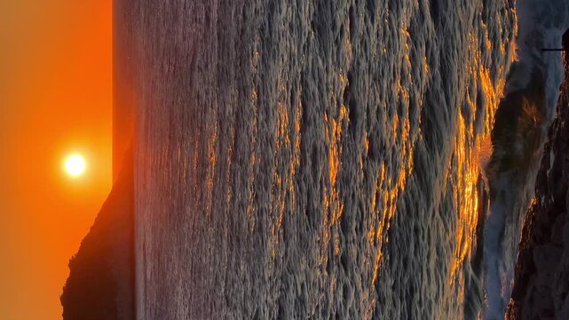 Sun and waves at golden light of sunset, Adriatic Sea in Croatia