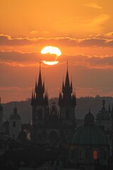 Fototapeta premium The sun rises between two towers In old town at Prague