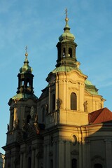 Fototapeta premium Sunrise in Prague. The sun shines on the towers