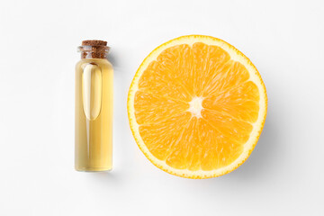 Bottle of essential oil and orange on white background, top view