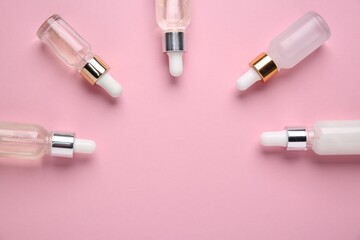 Different cosmetic products on pink background, flat lay. Space for text