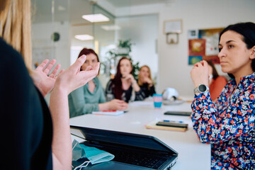 Fototapeta premium Diverse Business Team Discussing Projects in a Modern Glass Office.
