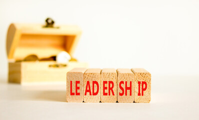 Leadership symbol. Concept word Leadership on beautiful wooden blocks. Beautiful white background. Beautiful wooden chest with coins. Business leadership concept. Copy space.