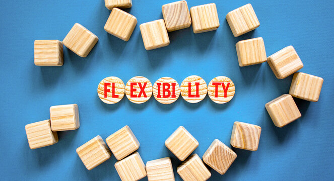 Flexibility symbol. Concept word Flexibility on beautiful wooden circles. Beautiful blue background. Beautiful wooden cubes. Business flexibility concept. Copy space.