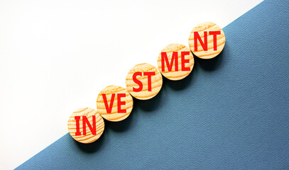 Investment symbol. Concept word Investment on beautiful wooden circles. Beautiful white and blue...