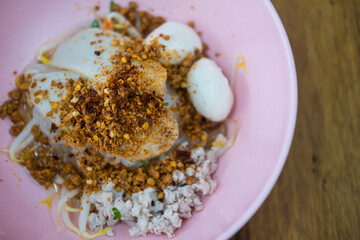 Thai dry noodle with minced pork in pink bowl. Delicious dry noodles