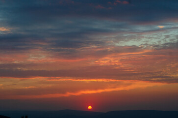 Dark Dramatic Sky Horizon Epic Sunset Clouds Landscape with Black Floor. Red sun, gradient sky high quality photo.