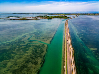 The magic of the Grado lagoon. Among the islands the ancient landing place and the church of San Marco. Beginning of Christian evangelization.