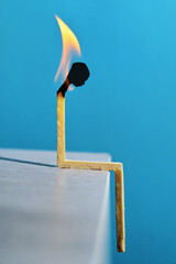 Person silhouette head match with flame light