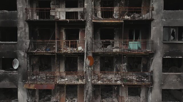 War in residential areas, broken windows and burned apartments. War in the city. City in war zone. Damage to a house as a result of artillery shelling. Armed conflict in Ukraine. High quality 4k