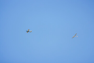 a small plane towing a glider for training.