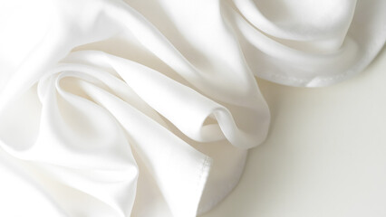Crumpled white silk fabric background with soft folds and delicate texture.