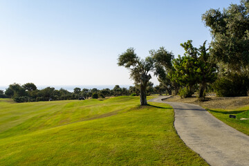 Golf teeing ground in golf course with sunrise background.