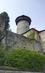 Castle defense tower with wooden ring. A defensive tower serving as a lookout point. Stone castle complex. Travel, sights, vacation, holidays