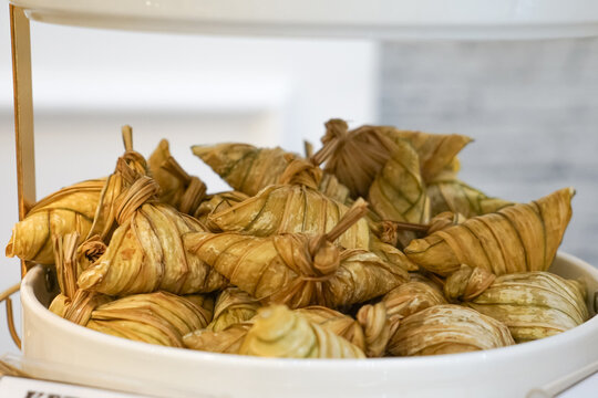 Ketupat palas or rice dumpling, boiled glutinous rice with coconut milk in casing made from young coconut leaves.