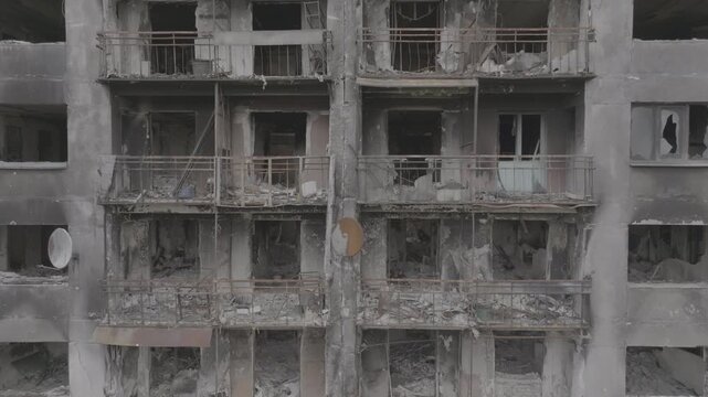War in residential areas, broken windows and burned apartments. War in the city. City in war zone. Damage to a house as a result of artillery shelling. Armed conflict in Ukraine. 10 bit ungraded D-LOG