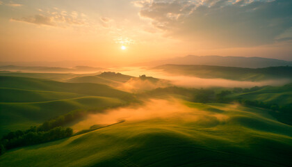 Fototapeta premium Aerial view of breathtaking sunrise over misty landscape with rolling hills and verdant fields