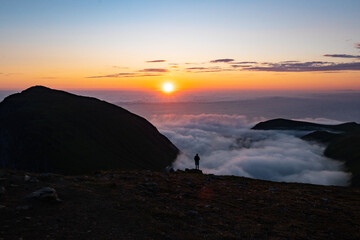 Sea of clouds at dramatic colorful evening sky during the midnight sun in the Lofoten, Northern...