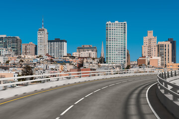 City skyline with high-rise buildings and a curved road.
