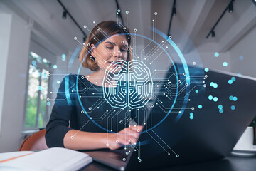 Woman working on laptop with digital brain hologram overlay.