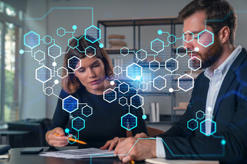 Business professionals analyzing data with futuristic technology overlay.