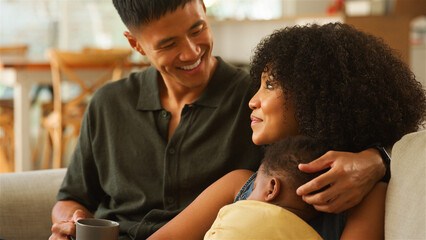 Family Bonding Moment at Home With Parents and Child in Cozy Living Room