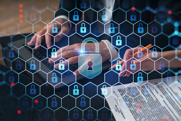 Cybersecurity concept with digital lock symbols over a laptop in office setting.