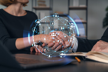 Business handshake with digital network overlay in office setting.