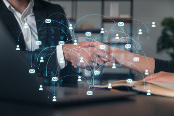 Handshake with digital icons overlay, symbolizing global communication.