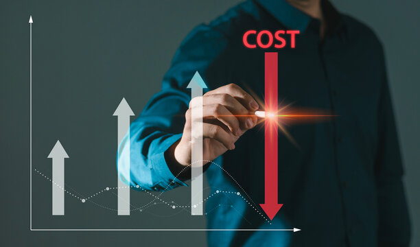 Cost reduction concept, businessman touches pen on virtual screen and decreases arrow of graph, cost text with down arrow, budget, cost management.